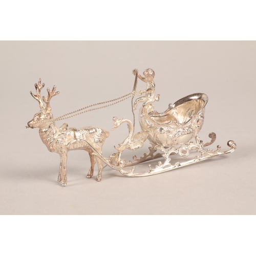 189 - Scandinavian 925  silver model of a reindeer pulling a sleigh with a putti aloft, 16cm.