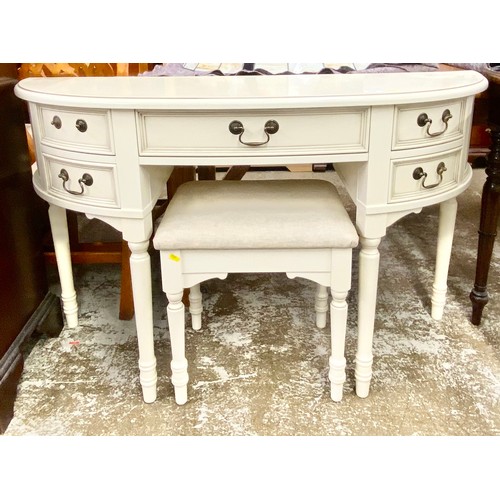 Demi-lune cream dressing table and stool, 123 x 77 x 42 cm.