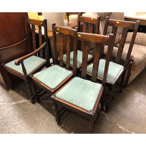 551 - Oak drop-leaf dining room table, a carver and four chairs.  (6)