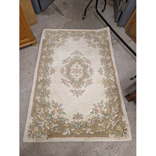 592 - Two cream ground floral rugs, 92cm x 152cm, and 120cm x 175cm.