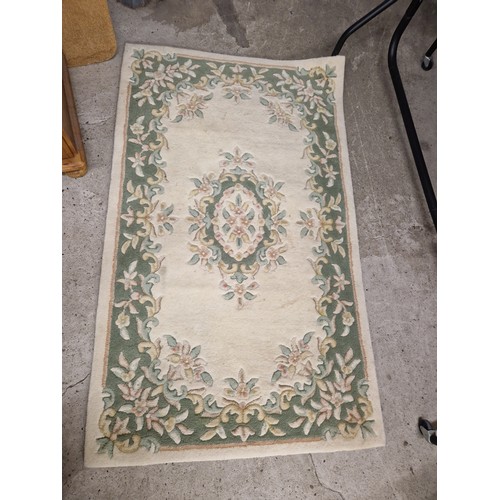 592 - Two cream ground floral rugs, 92cm x 152cm, and 120cm x 175cm.