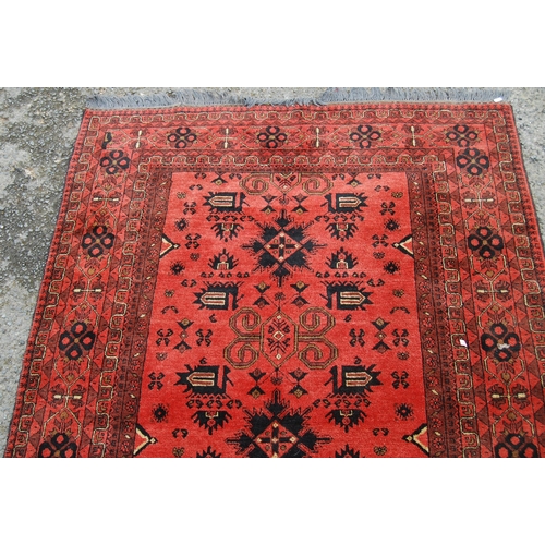 352 - Afghan Khal Mohammadi rug with all over floral and geometric lozenges on blue, cream and red ground,... 