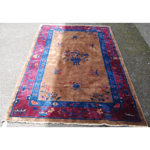 355 - Chinese rug, c. early 20th century, with all over floral panels on beige ground with a blue, wine an... 