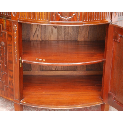 366 - Mahogany commode of demi-lune shape in the 18th century style, with a drawer above a cupboard door e... 