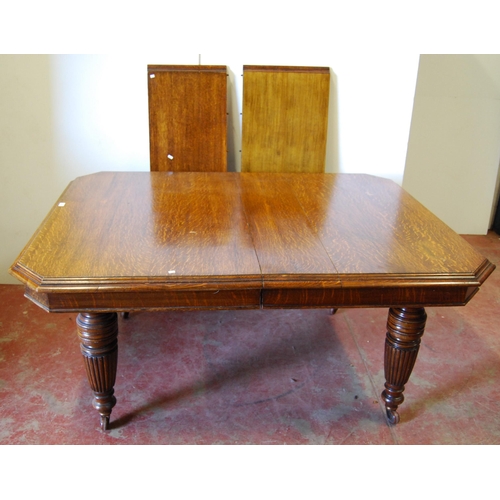 376 - Late Victorian oak extending dining table with two additional leaves, on reeded baluster legs and ca... 