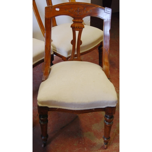 377 - Eleven walnut Klismos chairs decorated with roundels, upholstered in later fabric, on turned legs an... 