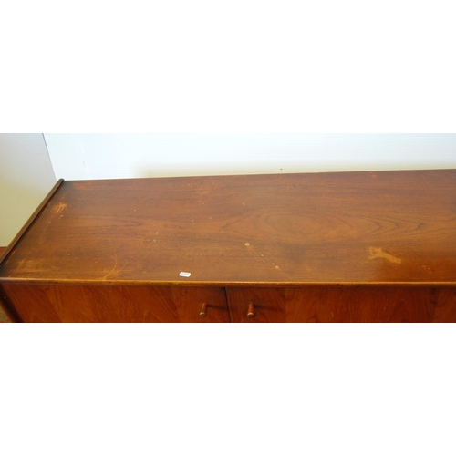 378 - Mid-20th century teak dining room suite comprising a sideboard, extending dining table, 76cm high, 1... 