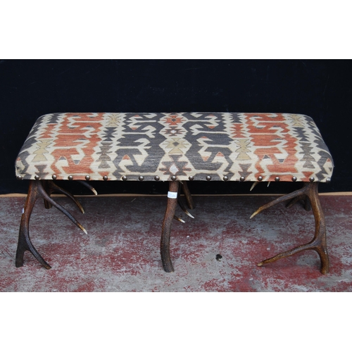 402 - Taxidermy interest: antler centre stool with Kilim upholstered stuff-over seat on six antler su... 