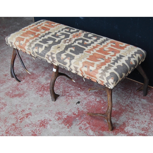 402 - Taxidermy interest: antler centre stool with Kilim upholstered stuff-over seat on six antler su... 