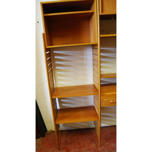 404 - Teak Ladderax unit, c. 1960s, with sliding doors to the top above open shelving and a drawer, flanke... 