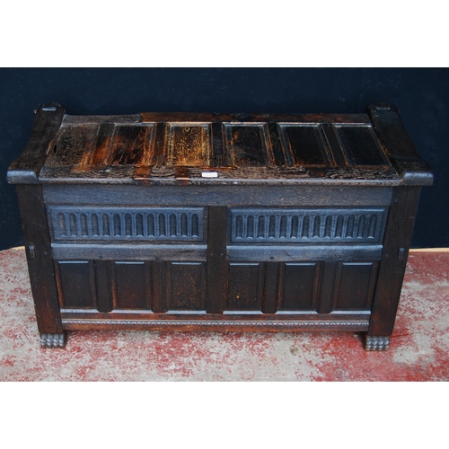 405 - Oak coffer, the hinged top and front with fielded panelling, naturalistic-style handles, on animal p... 