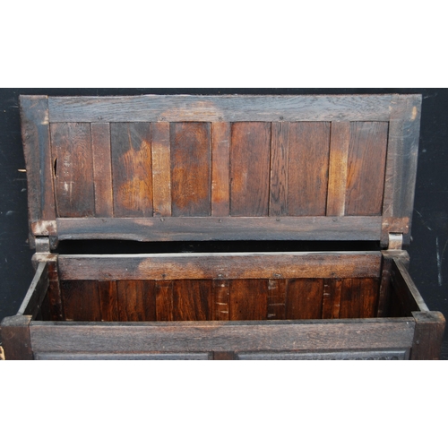 405 - Oak coffer, the hinged top and front with fielded panelling, naturalistic-style handles, on animal p... 