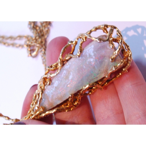 73 - Opal matrix pendant of tapering shape with 9ct gold twiggy mount, 29g gross, on 9ct gold necklet (11... 