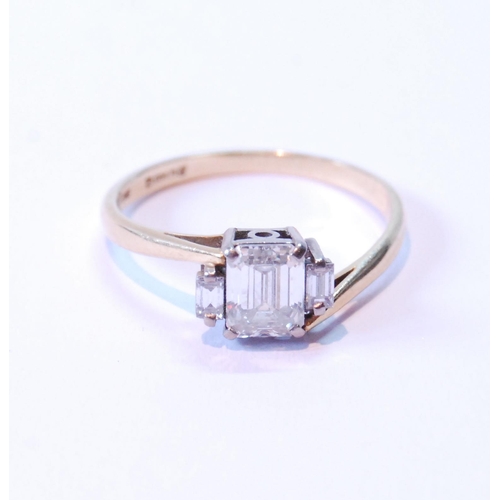 76 - Diamond three-stone baguette ring, the largest approximately 10mm x 5mm, flanked by two others, in 1... 