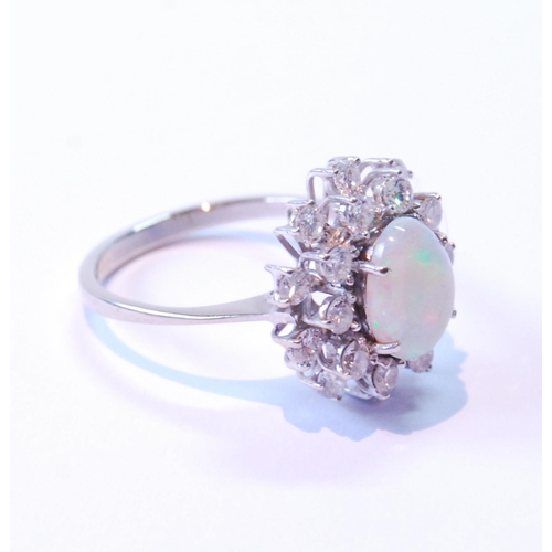 80 - Opal and diamond oval cluster ring with two tiers of brilliants, in white gold, '18ct', size Q.