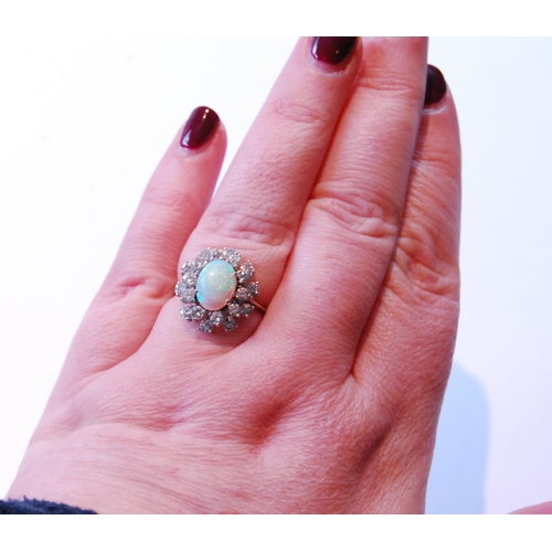 80 - Opal and diamond oval cluster ring with two tiers of brilliants, in white gold, '18ct', size Q.