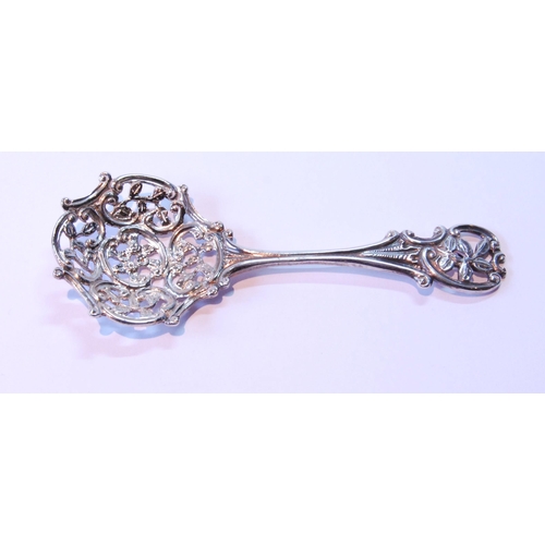 16 - Silver caddy spoon with pierced bowl and stem, by Huttons, 1891.