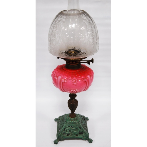 179 - Victorian oil lamp by Wright & Butler, Birmingham, with pink opaline reservoir above a gilt meta... 