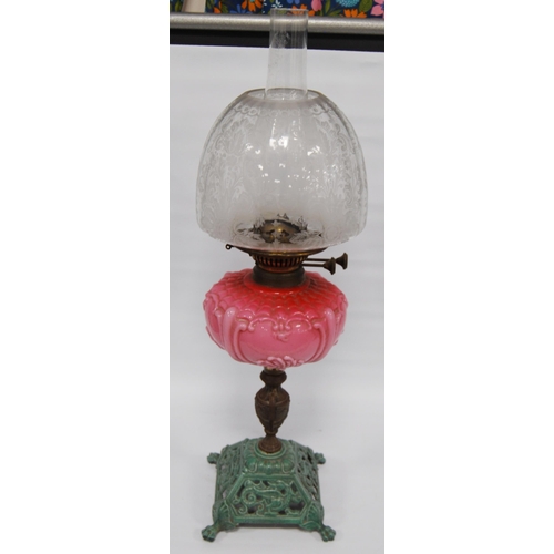 179 - Victorian oil lamp by Wright & Butler, Birmingham, with pink opaline reservoir above a gilt meta... 