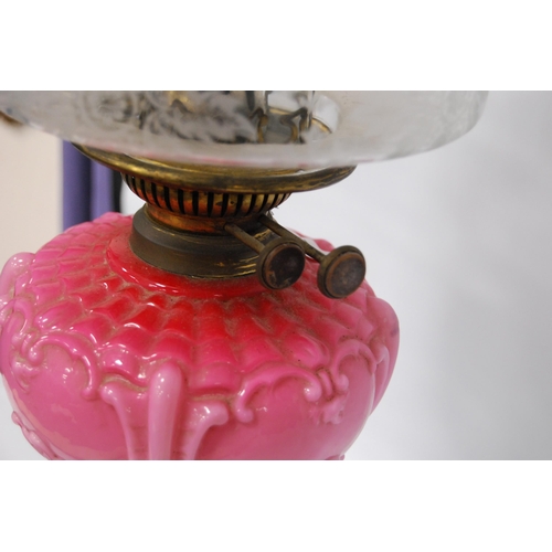 179 - Victorian oil lamp by Wright & Butler, Birmingham, with pink opaline reservoir above a gilt meta... 