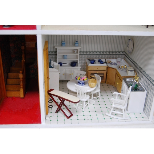 207 - Painted wood doll's house of large size with door opening to reveal six rooms with furnishings, 81cm... 