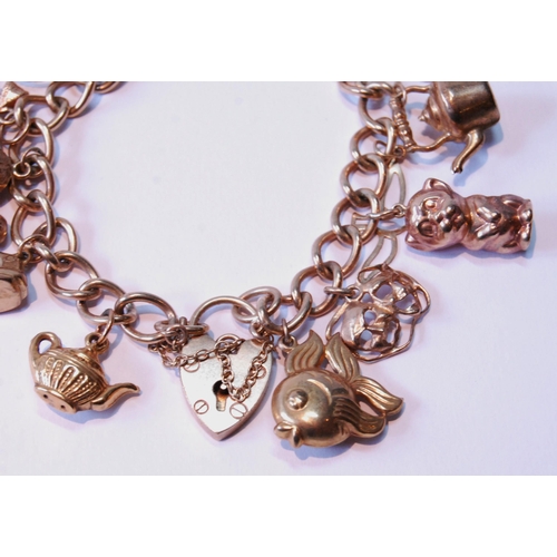 112 - 9ct gold charm bracelet, 34g.