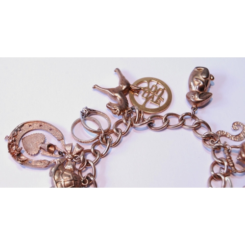 112 - 9ct gold charm bracelet, 34g.