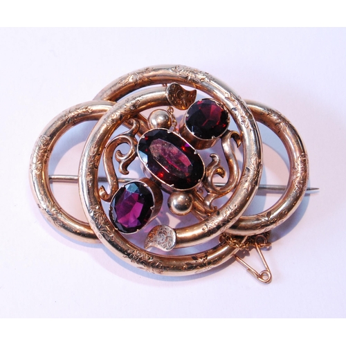 113 - Victorian gold-cased whorl brooch with three almandine garnets.