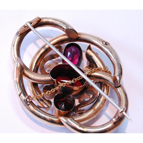 113 - Victorian gold-cased whorl brooch with three almandine garnets.