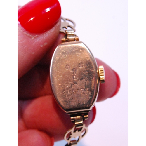 156 - 9ct gold lady's watch, 1925, on rolled gold bracelet.