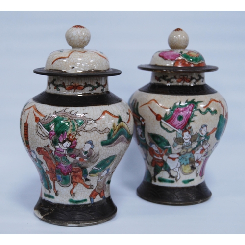 289 - Pair of Chinese crackle glazed baluster vases and covers (20th century) decorated with battle scenes... 