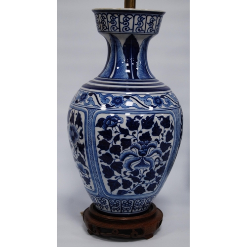 292 - Oriental blue and white porcelain vase/lamp in the Kangxi period style with all over floral panels, ... 