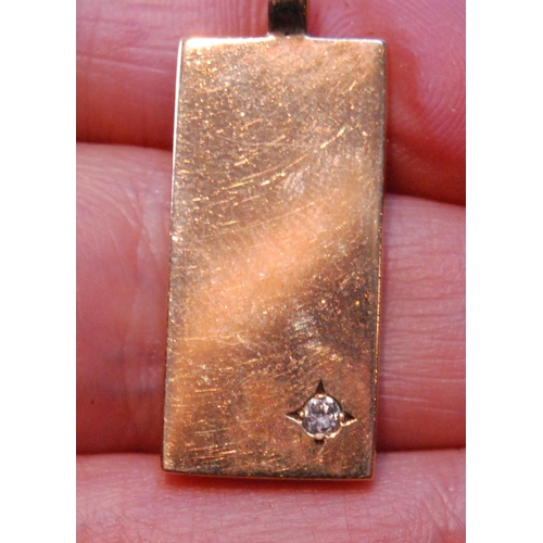 103 - 9ct gold plain rectangular pendant with diamond brilliant, 1978, 8.6g.