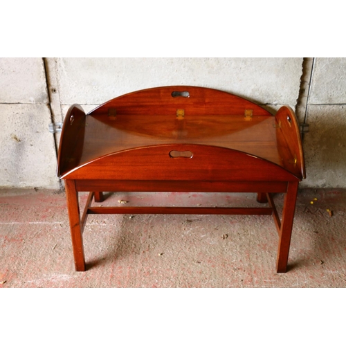 677 - Mahogany butler's tray on stand, the tray with four folding edges and pierced handles, 50 x 120 x 90... 