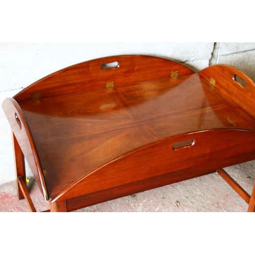 677 - Mahogany butler's tray on stand, the tray with four folding edges and pierced handles, 50 x 120 x 90... 