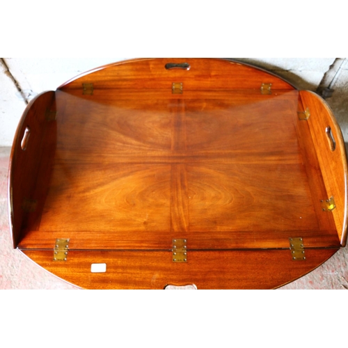 677 - Mahogany butler's tray on stand, the tray with four folding edges and pierced handles, 50 x 120 x 90... 