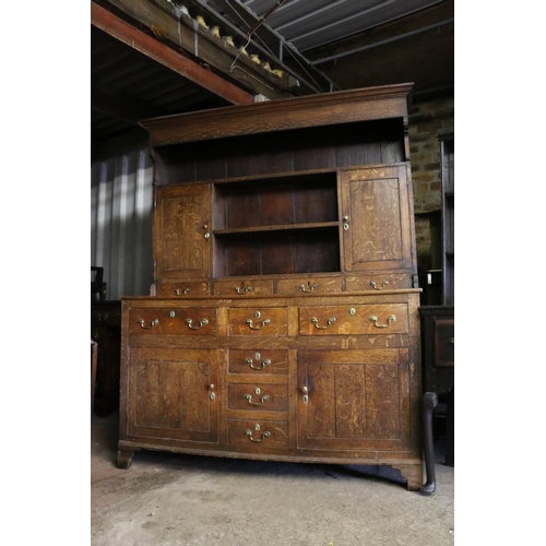 680 - Georgian oak dresser, the moulded cornice over plate rail, with shelves and cupboards, on base with ... 