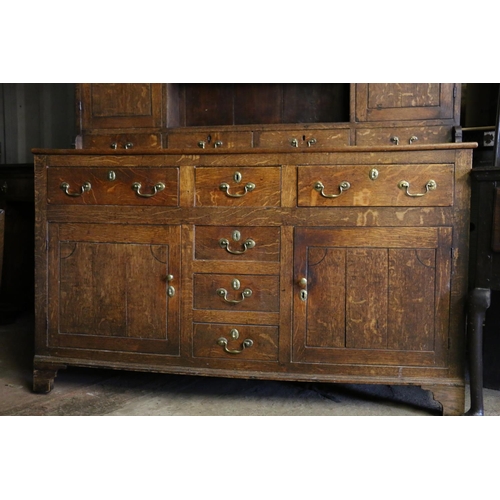 680 - Georgian oak dresser, the moulded cornice over plate rail, with shelves and cupboards, on base with ... 