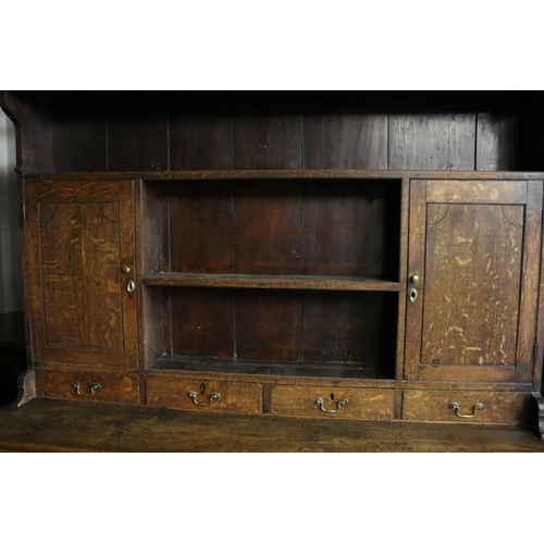 680 - Georgian oak dresser, the moulded cornice over plate rail, with shelves and cupboards, on base with ... 