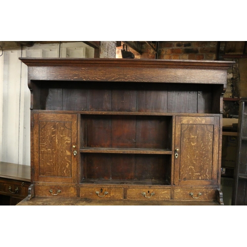 680 - Georgian oak dresser, the moulded cornice over plate rail, with shelves and cupboards, on base with ... 