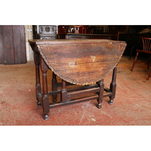 682 - Early 19th century oak Pembroke table, the oval top with piecrust edge, single drawer, raised on tur... 