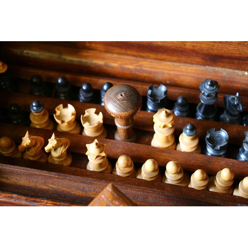 688 - Late 19th century oak games compendium complete with chess set, cards and bone dominos. raised on tr... 