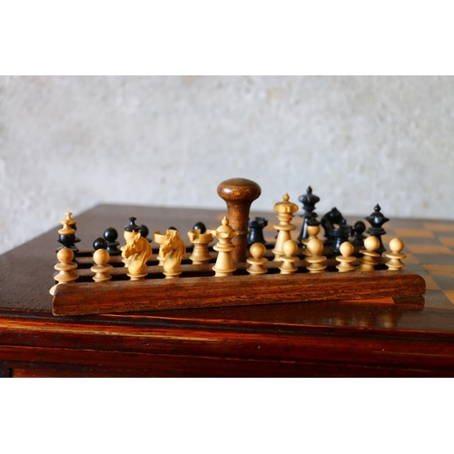 688 - Late 19th century oak games compendium complete with chess set, cards and bone dominos. raised on tr... 