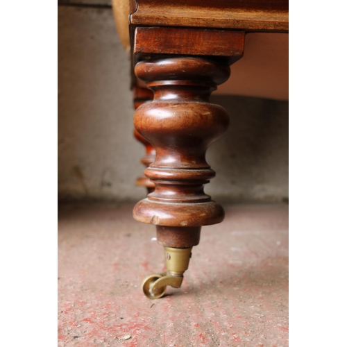 690 - Victorian mahogany sofa, with scrolled arms and acanthus detail, raised on turned supports terminati... 