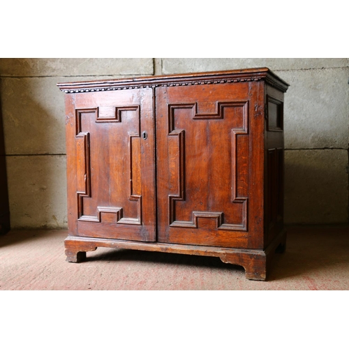 702 - 18th century French oak cabinet, with rectangular top, moulded edge, dentil cornice over two geometr... 