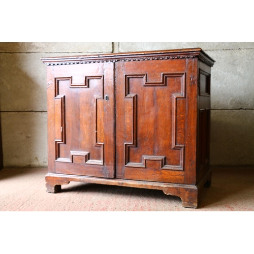 702 - 18th century French oak cabinet, with rectangular top, moulded edge, dentil cornice over two geometr... 