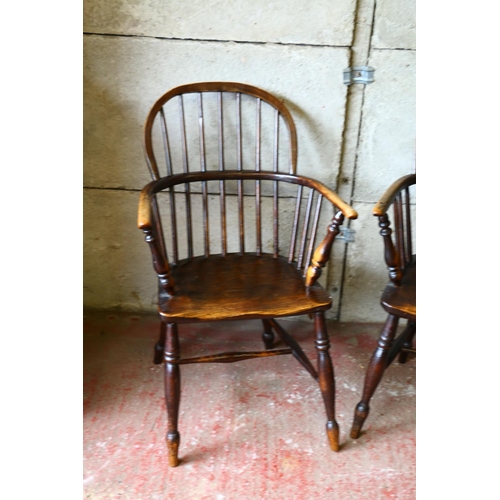 715 - Pair of 19th century elm Windsor chairs, with saddle seats, raised on turned supports united by H-st... 