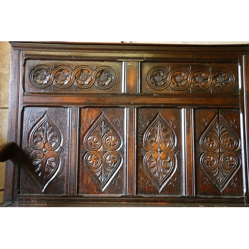 733 - 18th century settle, with panelled carved back, hinged seat over unfitted interior, 136 x 143 x 455c... 