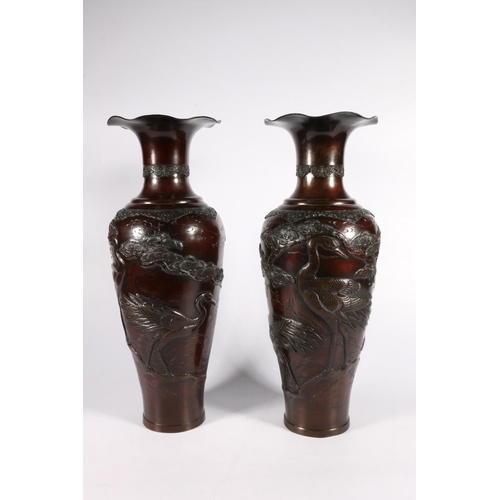 520 - Pair of Japanese bronze vases of baluster form with flared rims and cranes within trees in relief, 4... 