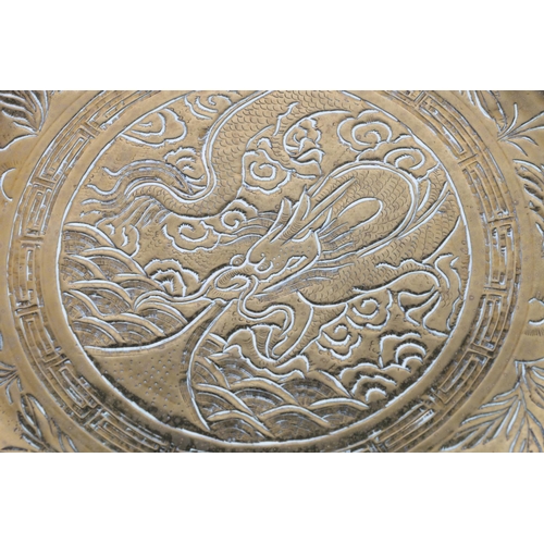 521 - Chinese bronze plate depicting single dragon to well surrounded by edge having two dragons, flaming ... 